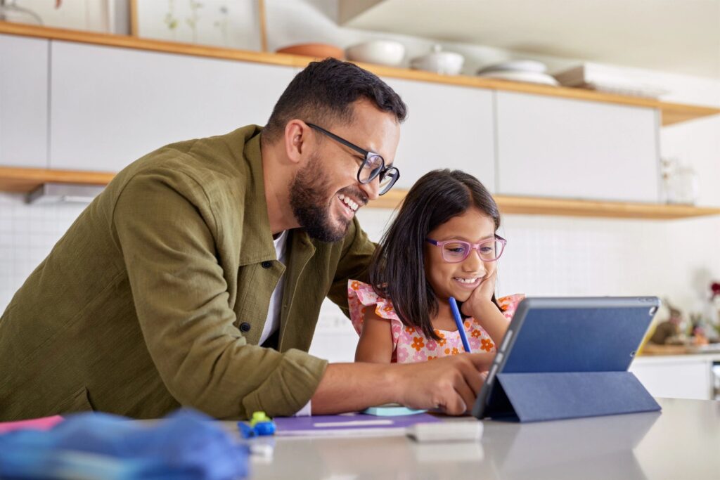 Adult instructor teaching child on a tablet